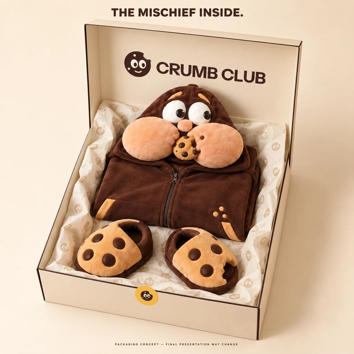 Packaging concept: a folded Goinfre onesie and separate cookie slippers in a Crumb Club box. Final presentation may change.